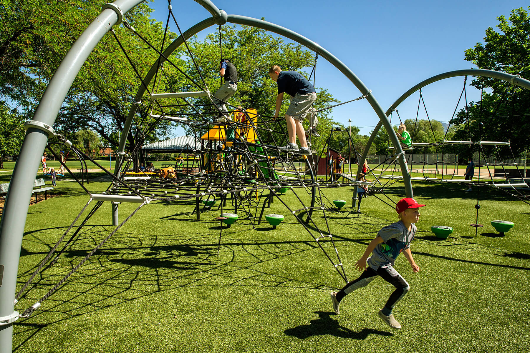 Children playing on a playground with artificial turf